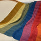 Colorful striped shawl draped over the back of a sofa at the Hillsborough Yarn Shop. 