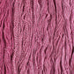 Skeins of cerise pink Brooklyn Tweed Dapple yarn. 