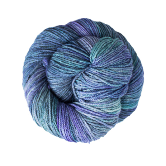 Skein of variegated blue and purple Malabrigo Finito yarn. 