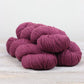 3 skeins of raspberry pink Fibre Co. Cumbria yarn. 