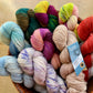 Colorful skeins of variegated Fleece Artist / Hand Maiden Bluenose Socks yarn at Hillsborough Yarn Shop