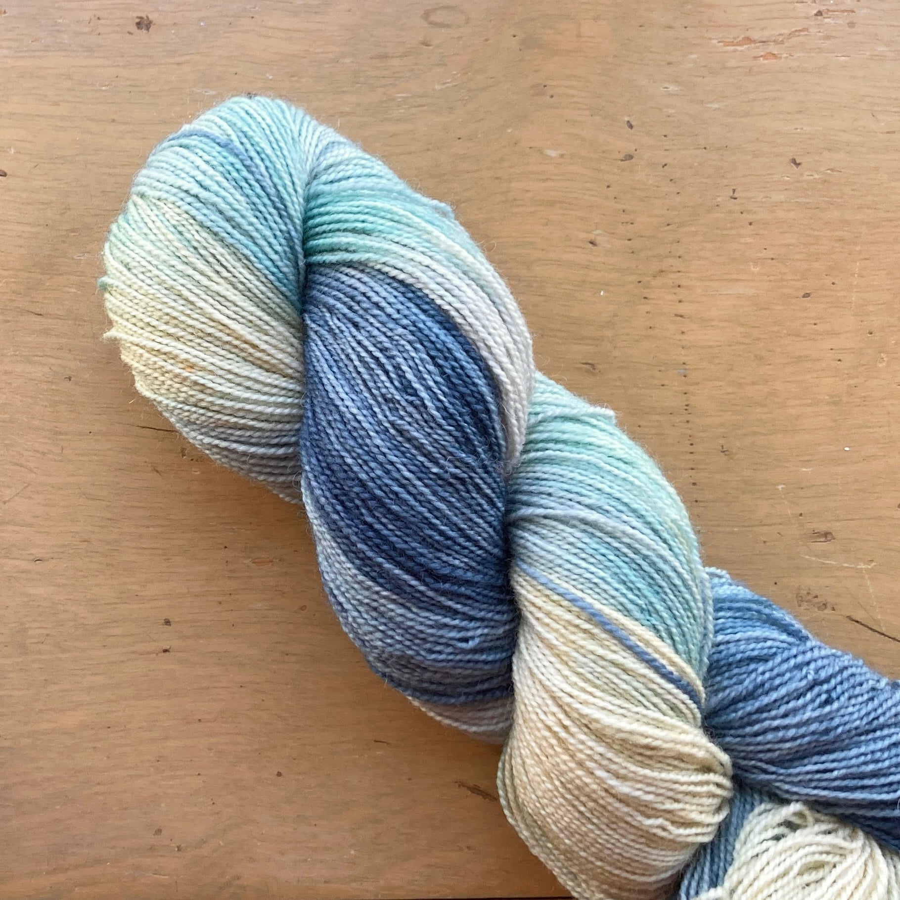 Variegated blue, cream, and seafoam Fleece Artist / Hand Maiden yarn, colorway Tundra