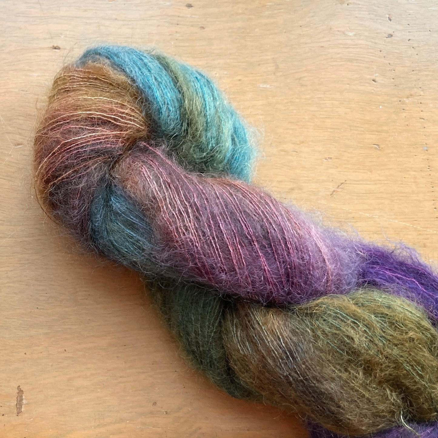 Variegated jewel tone skein of Fleece Artist / Hand Maiden Superkid Silk yarn, colorway Paris