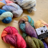 Colorful skeins of Fleece Artist / Hand Maiden Superkid Silk yarn on display at Hillsborough Yarn Shop