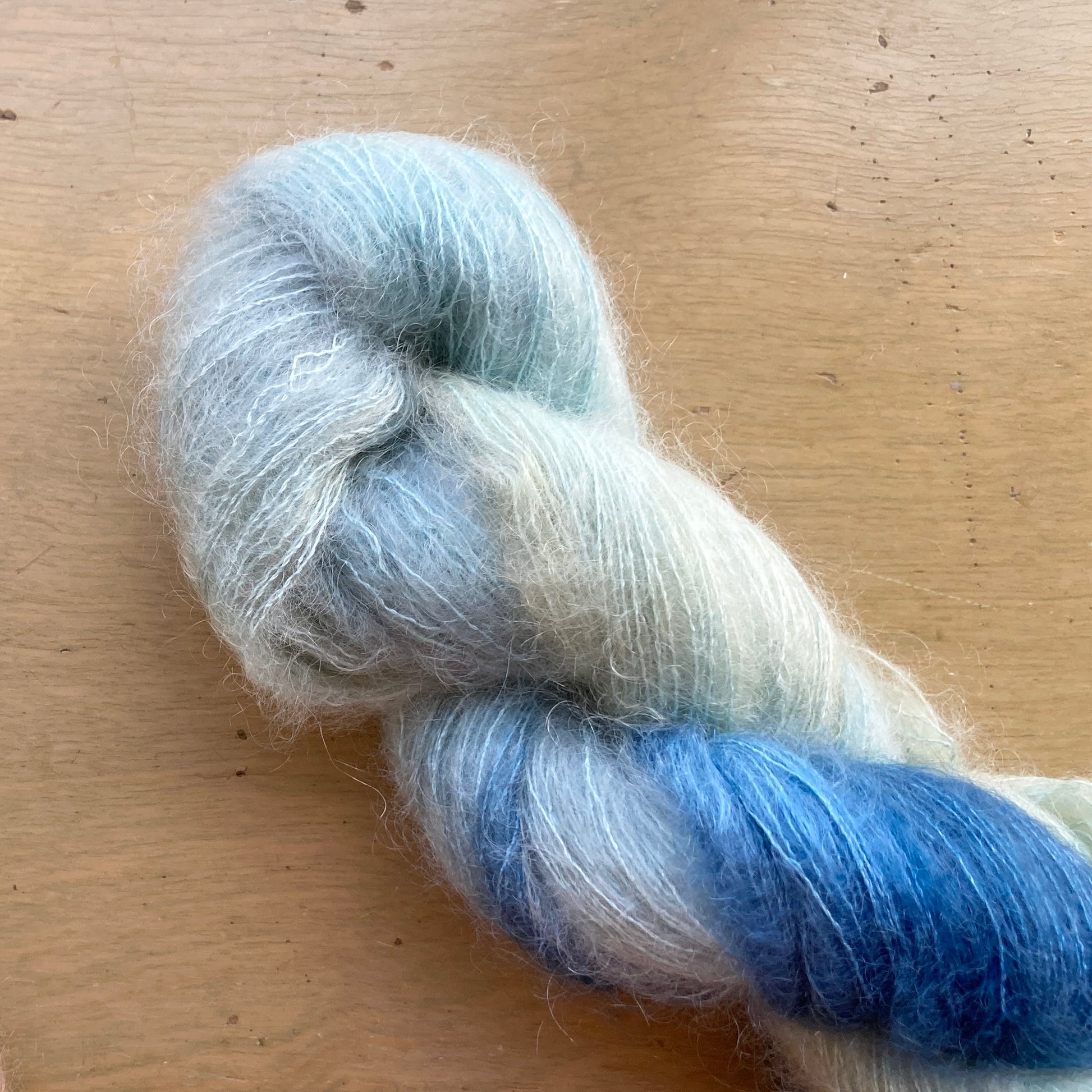 Variegated blue and seafoam skein of Fleece Artist / Hand Maiden Superkid Silk yarn, colorway Tundra