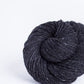 Black tweed ball of Brooklyn Tweed Loft yarn. 