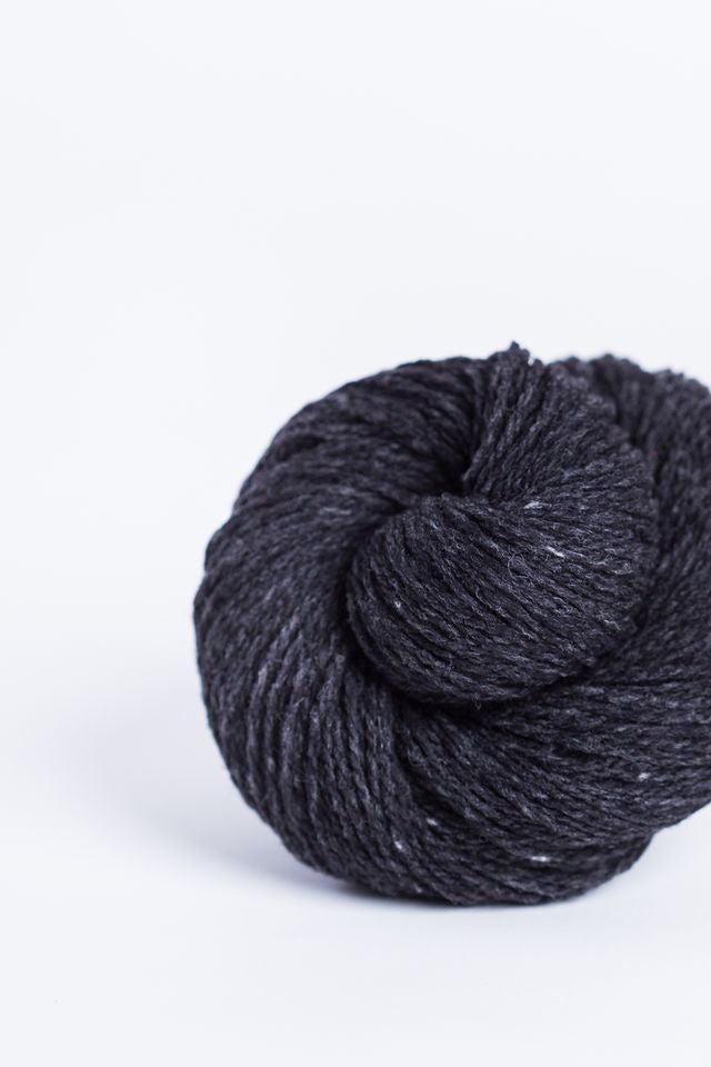 Black tweed ball of Brooklyn Tweed Loft yarn. 