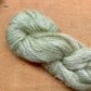 Sage eucalyptus green skein of Fleece Artist / Hand Maiden Superkid Silk yarn. 