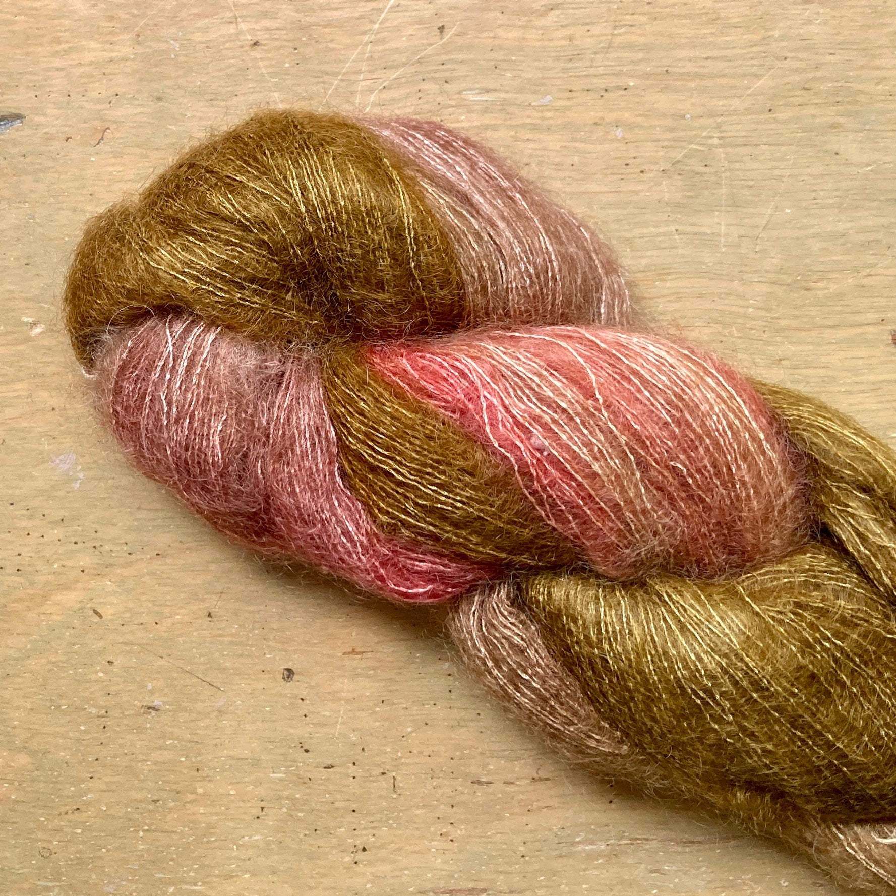 Variegated bronze and pink skein of Hand Maiden Superkid Silk yarn, Fauna colorway