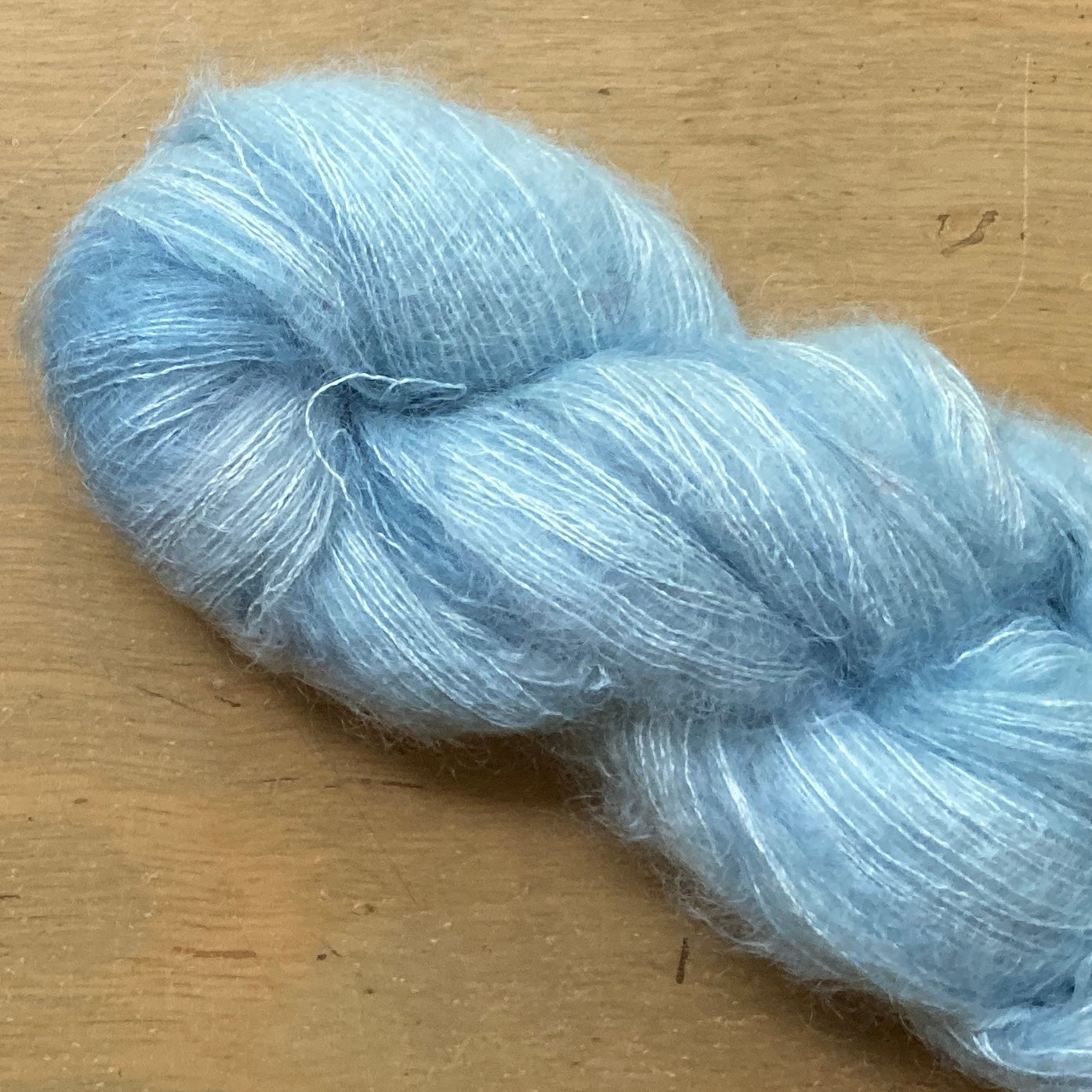 Light blue skein of Hand Maiden Superkid Silk yarn. 