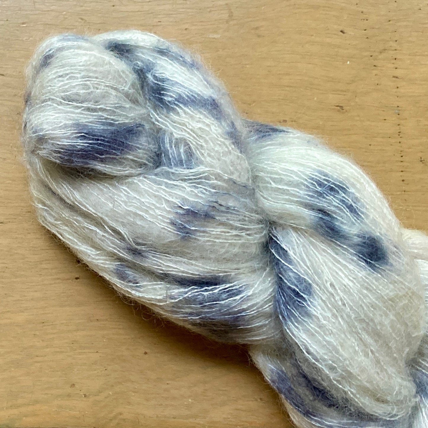 Speckled black and cream skein of Hand Maiden Superkid Silk yarn. 