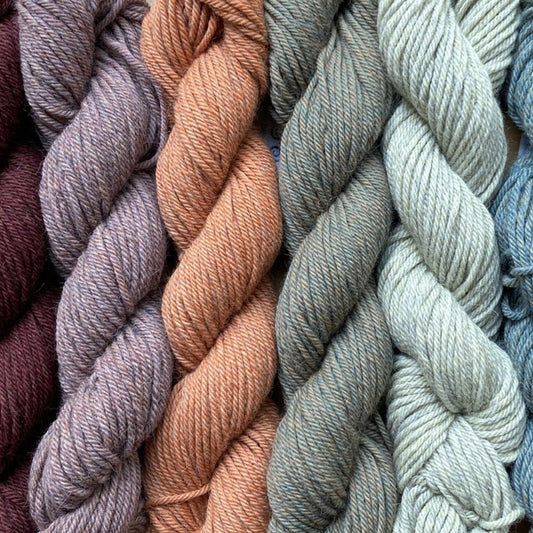 Collection of colorful skeins of Kate Davies Designs Àrd-Thìr yarn. 