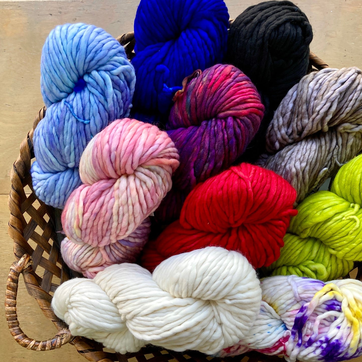 Basket of colorful skeins of Malabrigo Rasta yarn. 