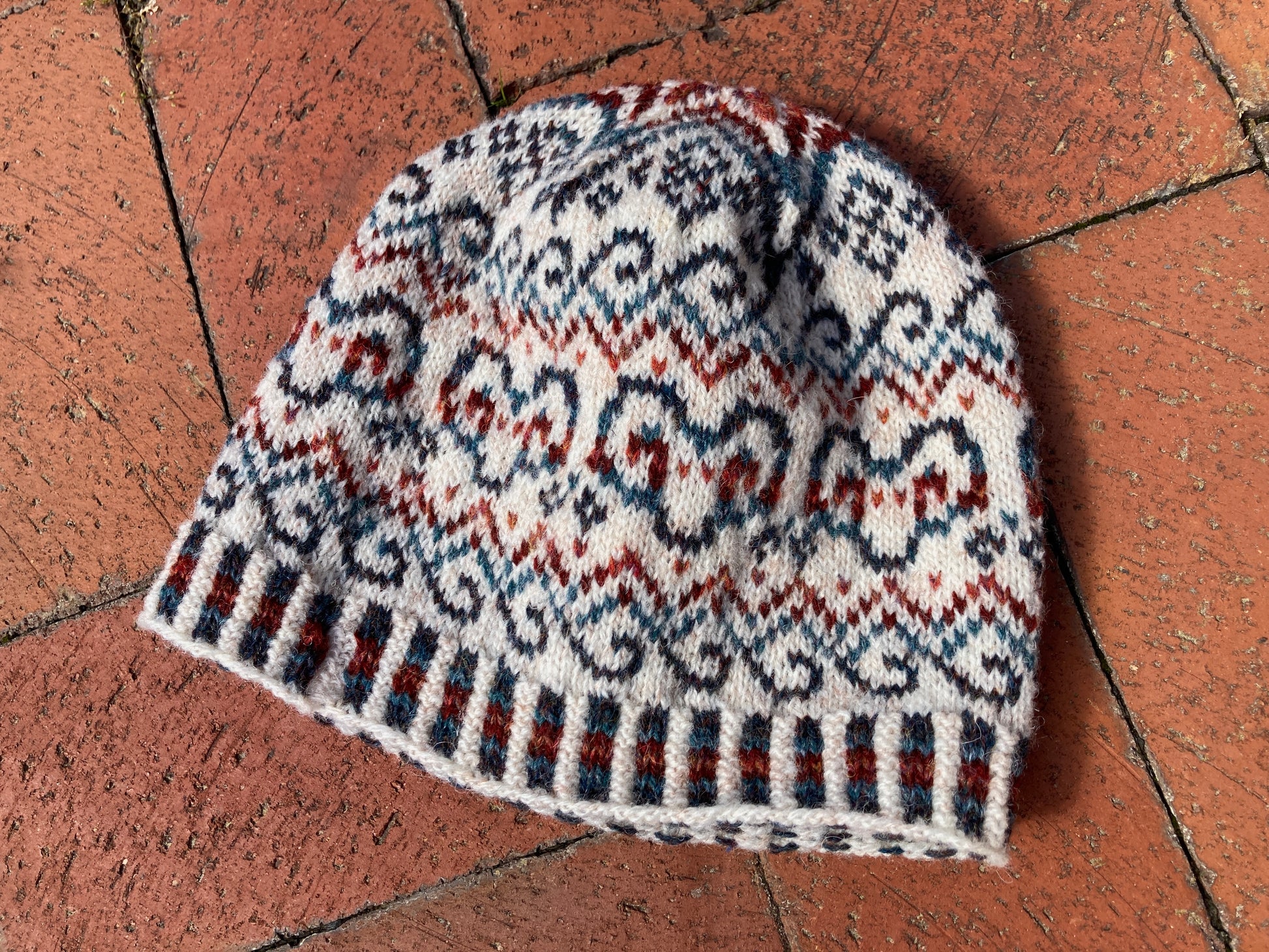 Sample knit colorwork hat with ram motifs, knit in Jamieson's Shetland Spindrift yarn.