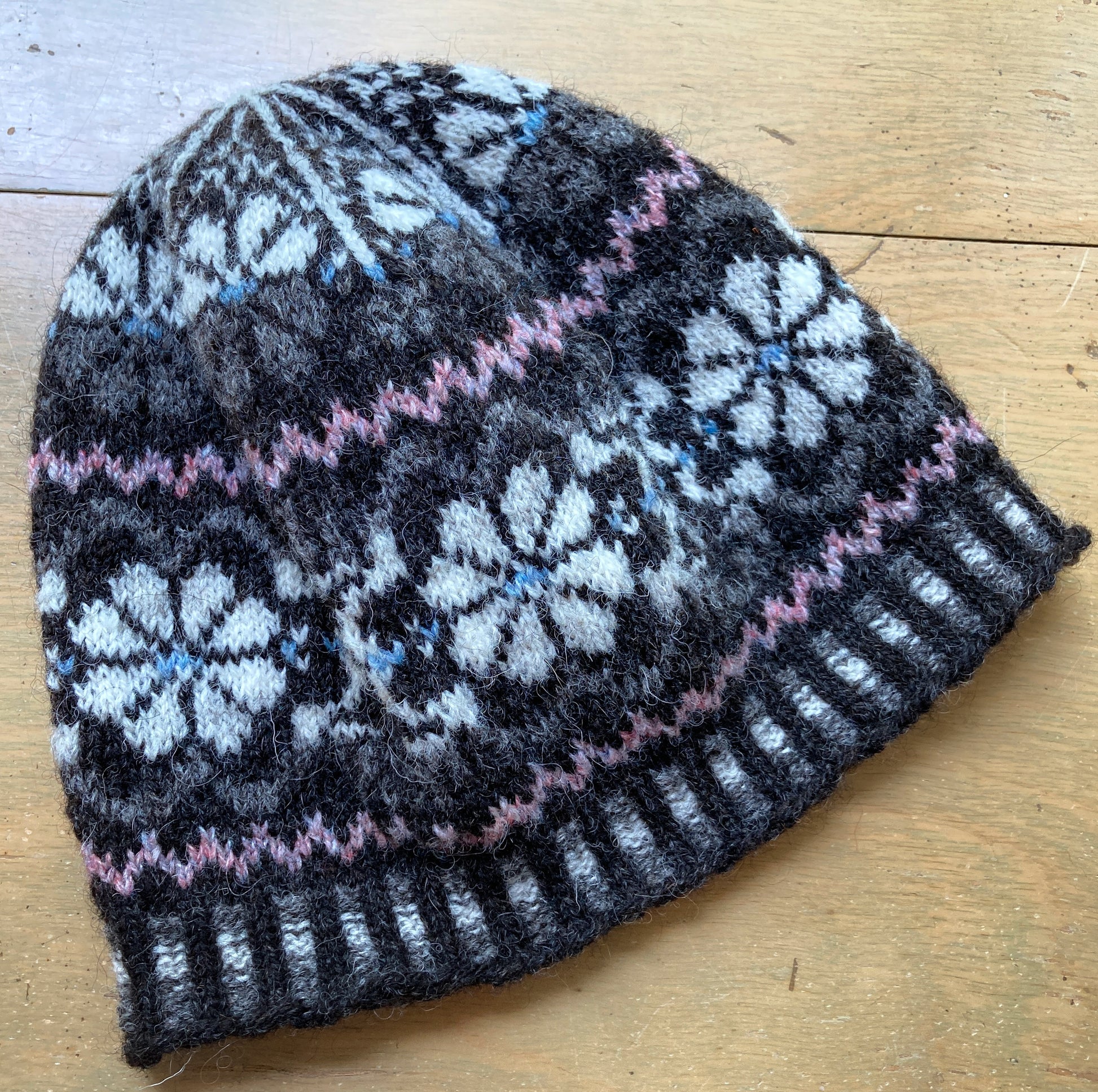 Sample knit colorwork hat with flower motifs, knit in Jamieson's Shetland Spindrift yarn.