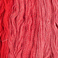 Skeins of bright red Brooklyn Tweed Dapple yarn. 