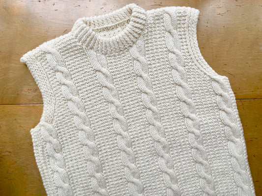 Natural white cabled vest knit with Kelbourne Woolens Erin yarn, on display at the Hillsborough Yarn Shop