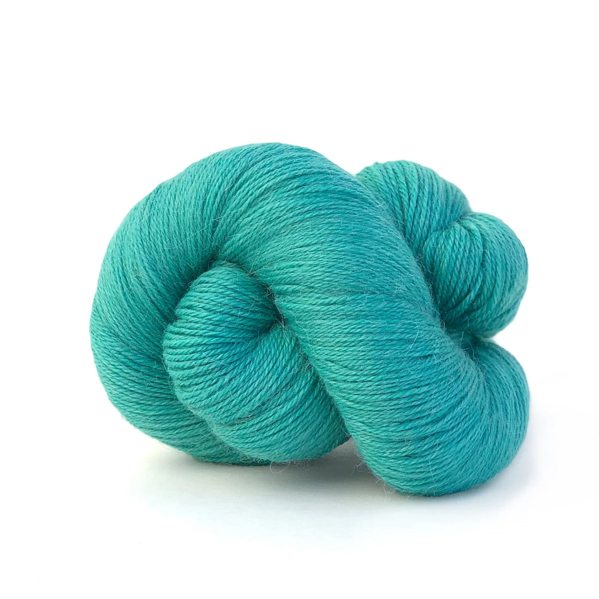 Close-up of a skein of medium sea blue/green Perennial yarn by Kelbourne Woolens in color Carribean.