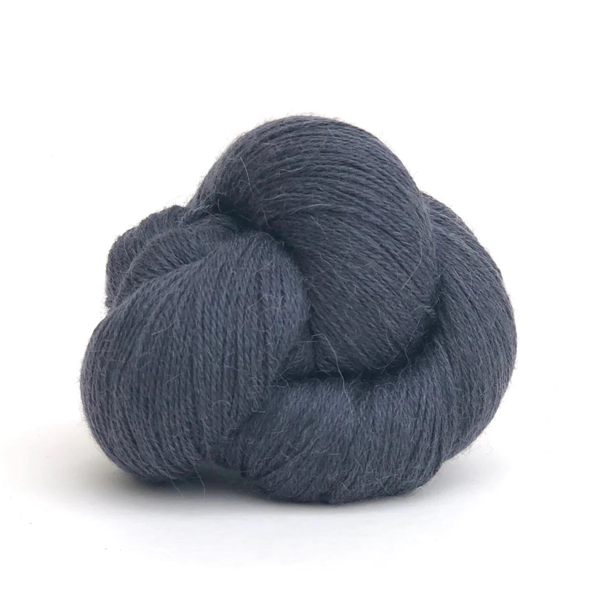 Close-up of a skein of dark gray Perennial yarn by Kelbourne Woolens in color Lead.