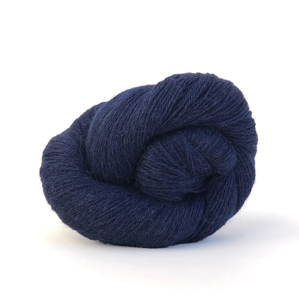 Close-up of a skein of dark blue Perennial yarn by Kelbourne Woolens in color Midnight.