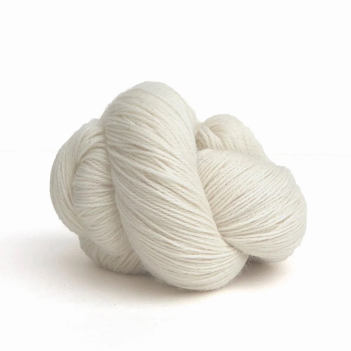 Close-up of a skein of white Perennial yarn by Kelbourne Woolens in color Natural.