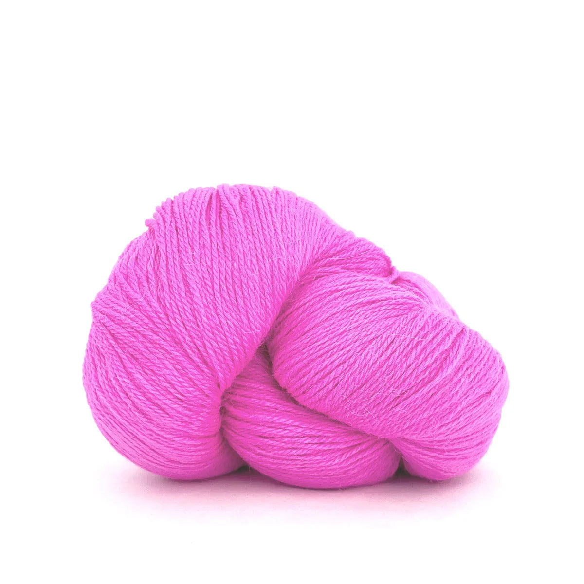 Close-up of a skein of bubblegum pink Perennial yarn by Kelbourne Woolens in color Pink.