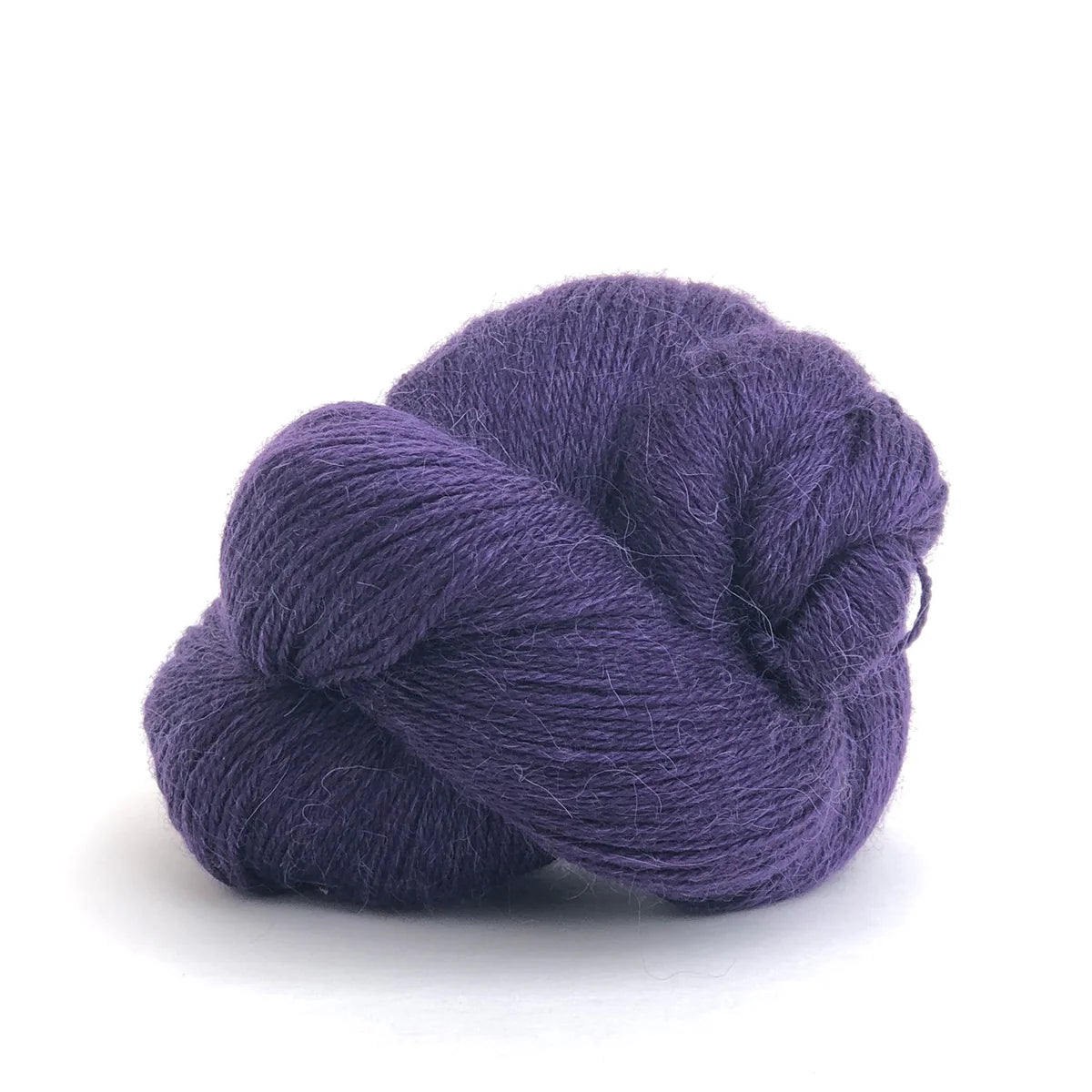 Close-up of a skein of dark purple Perennial yarn by Kelbourne Woolens in color Purple.