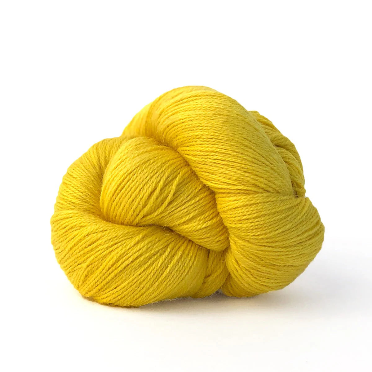 Close-up of a skein of yellow Kelbourne Woolens Perennial yarn, color Pineapple.