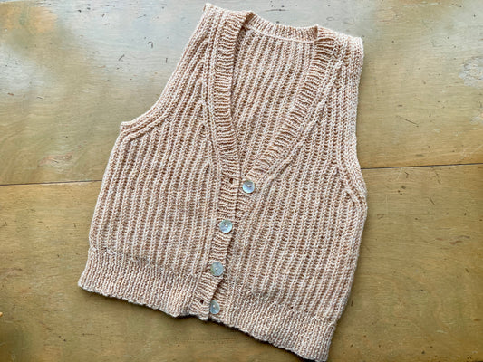 A sample of the Ribblesdale Vest by Lily Kate France, knit in Kelbourne Woolens Scout in the color Wheat Heather.