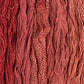 Skeins of rust red Brooklyn Tweed Dapple yarn. 