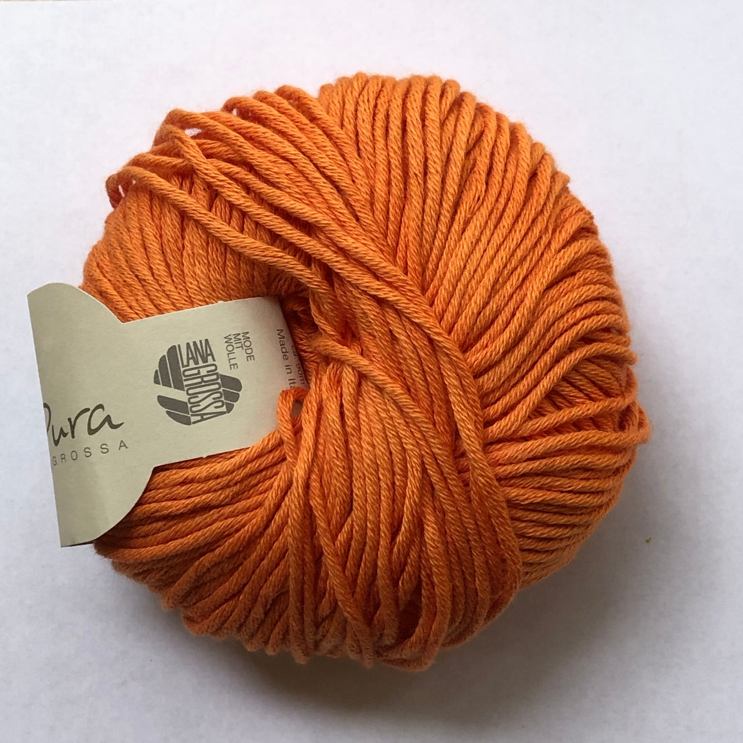 Ball of Lana Grossa Organico cotton yarn in orange. 