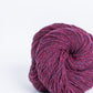 Mulberry pink ball of Brooklyn Tweed Loft yarn. 