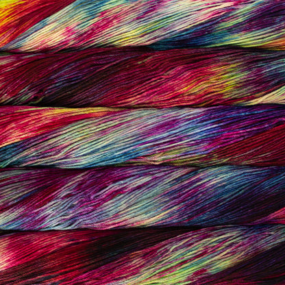 Skein of variegated red, blue, yellow, and purple Malabrigo Arroyo yarn. 