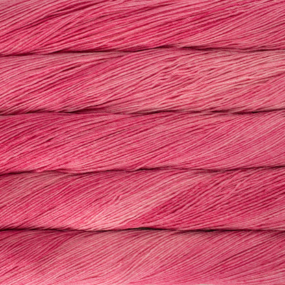 Skein of semisolid hot pink Malabrigo Arroyo yarn. 
