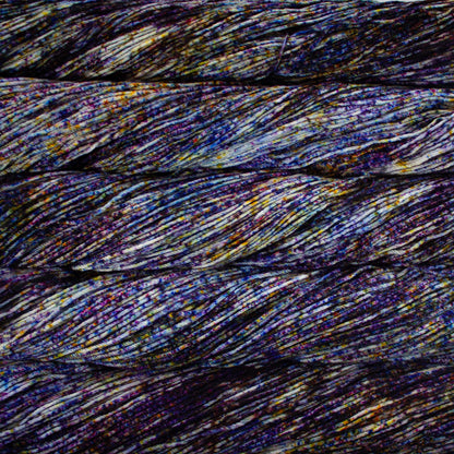 Skein of speckled blue, purple, and white Malabrigo Arroyo yarn. 