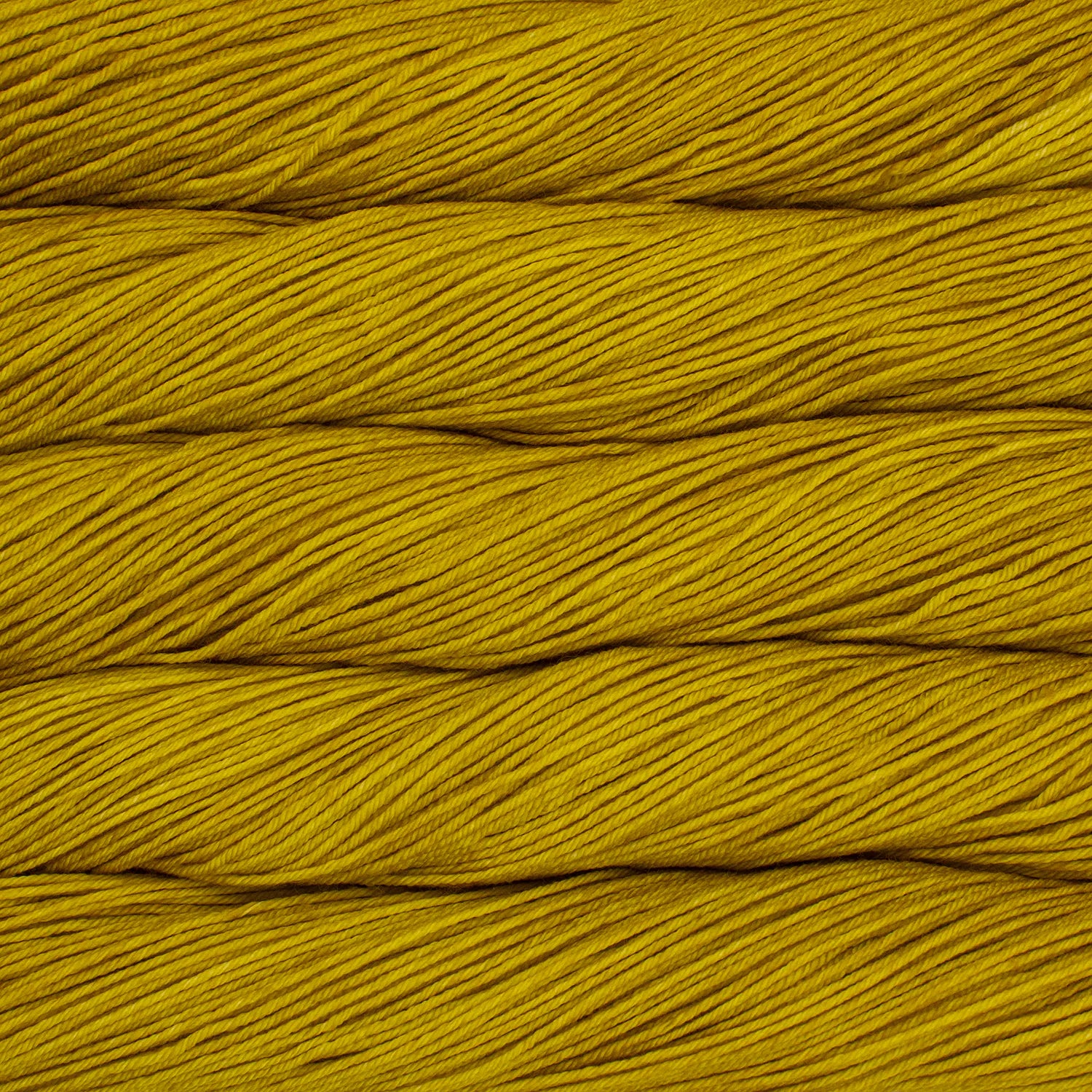 Skein of semisolid mustard yellow Malabrigo Arroyo yarn. 
