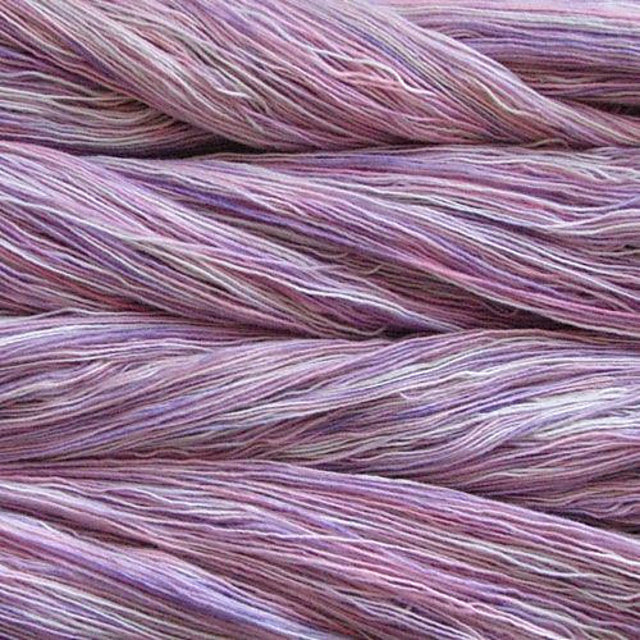 Close up on variegated pink and lavender skeins of Malabrigo Lace yarn. 