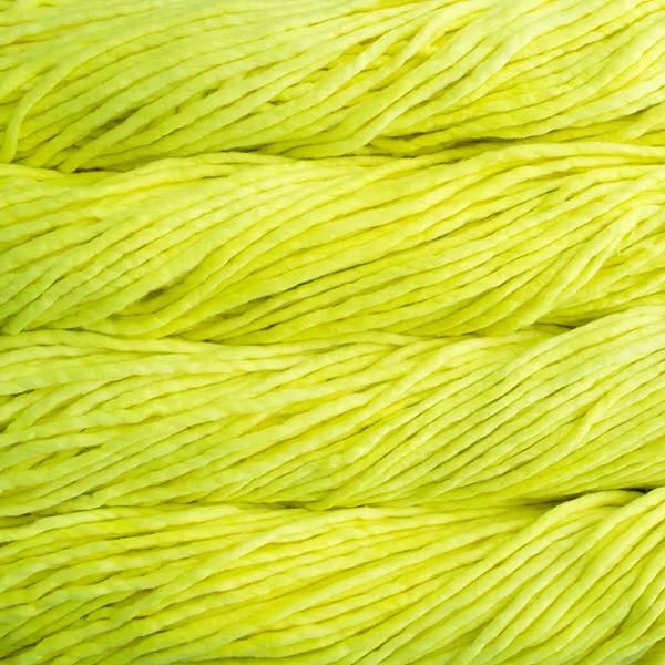 Close up on neon yellow skein of Malabrigo Rasta yarn in color Fluo. 