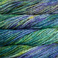 Close up on variegated blue and green skein of Malabrigo Rasta yarn in color Indiecita. 