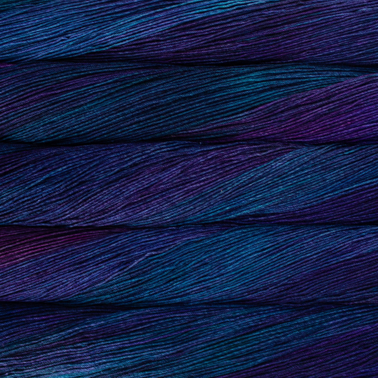 Variegated skeins of dark purple and blue yarn - Ultimate Sock by Malabrigo in Whales Road