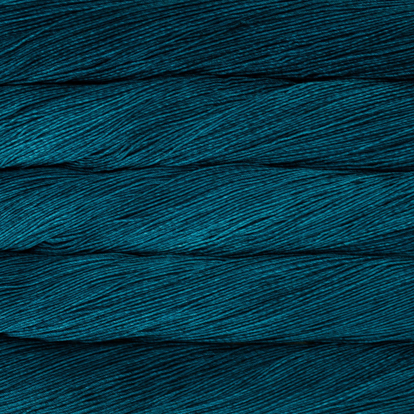 Variegated skeins of deep teal yarn - Ultimate Sock by Malabrigo in Teal Feather