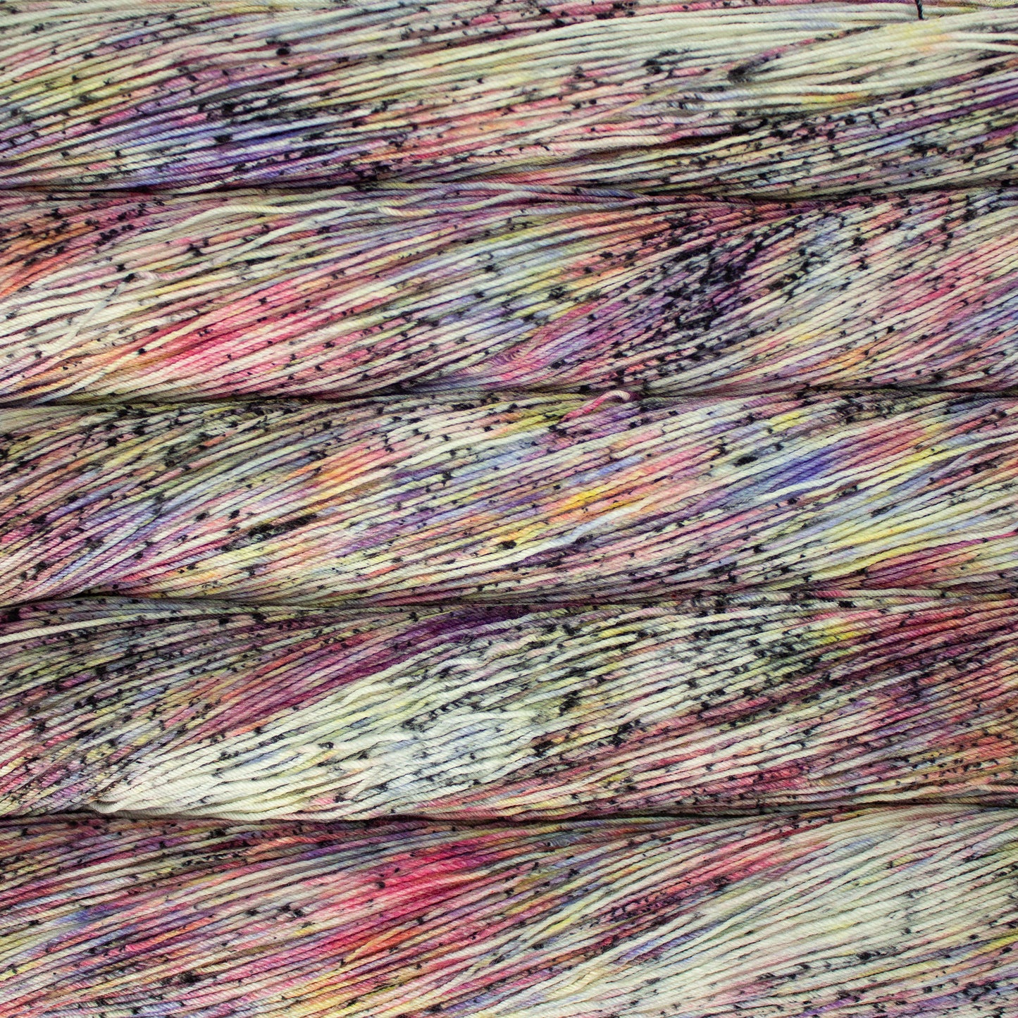 Variegated rainbow yarn with black speckles - Ultimate Sock by Malabrigo in Gloria