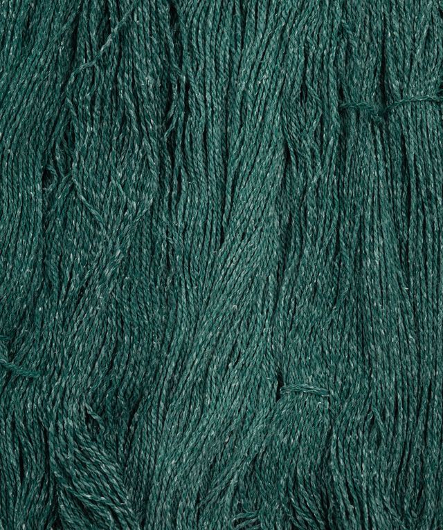 Skeins of emerald green Brooklyn Tweed Dapple yarn. 