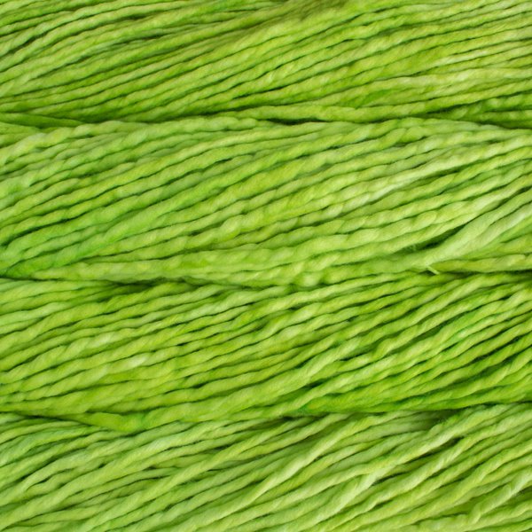 Close up on neon green skein of Malabrigo Rasta yarn. 