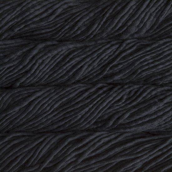 Close up on black skein of Malabrigo Rasta yarn. 