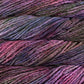 Close up on purple variegated skein of Malabrigo Rasta yarn in color Dreamscape. 