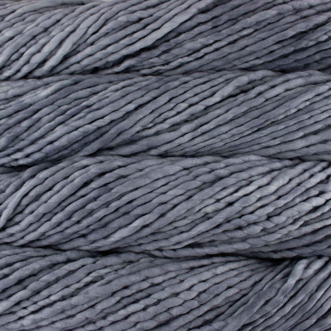 Close up on medium gray skein of Malabrigo Rasta yarn in color Gris