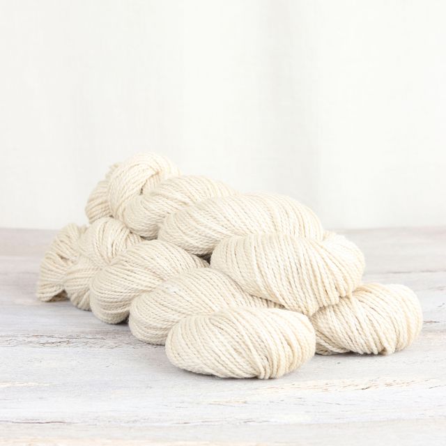 3 skeins of white Fibre Co. Acadia yarn. 