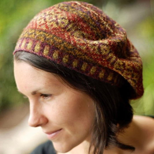 Person wearing handknit colorwork tam. 