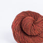 Rust red ball of Brooklyn Tweed Loft yarn. 